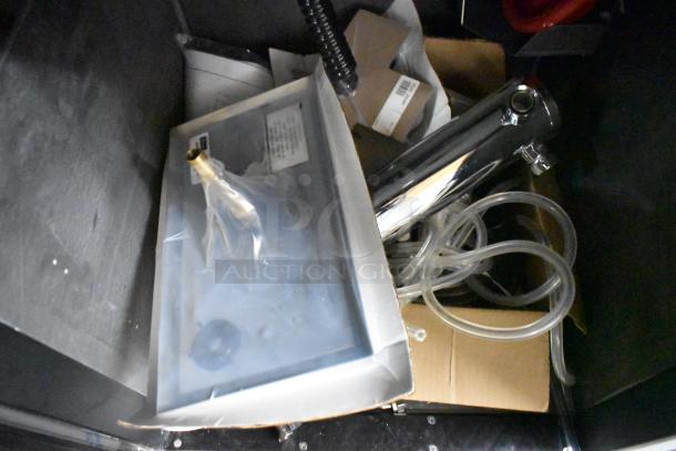 Alt text: Brand new Perlick DDS36 beer dispenser parts in packaging; includes hoses, a stainless steel tower, labels visible.