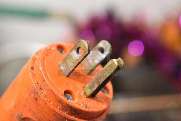 Close-up of a worn orange electrical plug prongs, part of a Hobart 84185 Buffalo Chopper, 115V, 1 Phase.