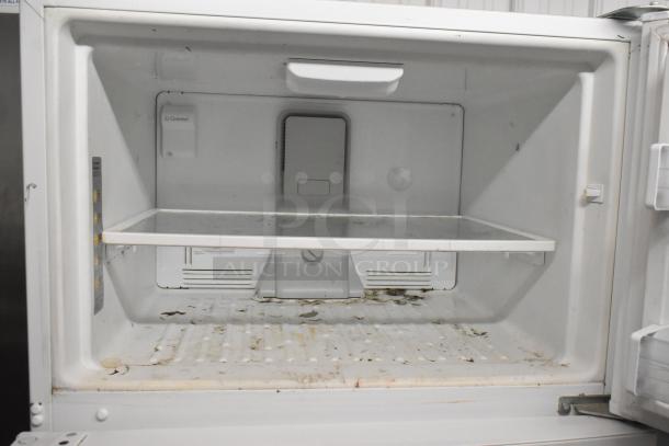 Whirlpool WRT51SZDW05 reach-in cooler with freezer interior. Features shelving, signs of wear. 115 Volts, 1 Phase.
