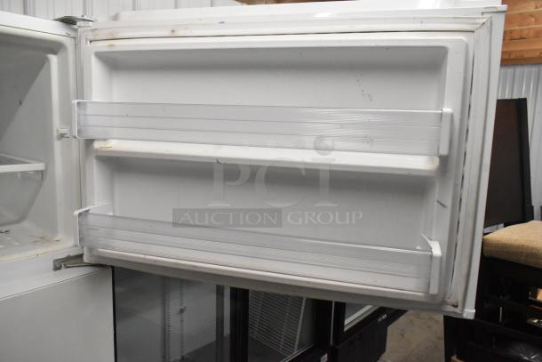 Whirlpool WRT51SZDW05 reach-in cooler with freezer, white interior, showing minor wear, 115 volts, 1 phase.