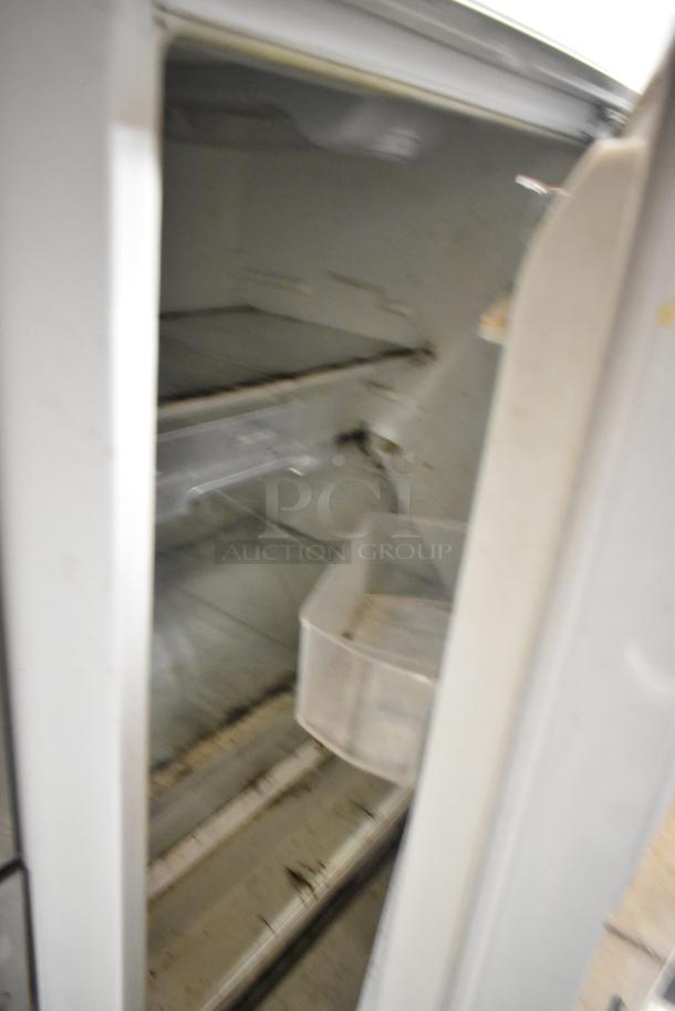 Whirlpool WRT51SZDW05 Reach-In Cooler with freezer, 115 volts, 1 phase, visible wear and interior marks.