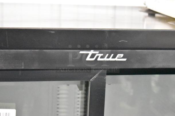2018 True GDM-41SL-48-HC-LD commercial cooler, black metal frame, True logo, poly coated racks, excellent condition.
