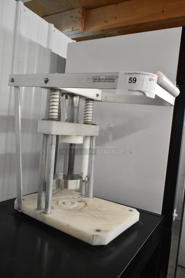Metal countertop pineapple corer with spring mechanism. Features sturdy construction, used condition. Auction tag reads "59".