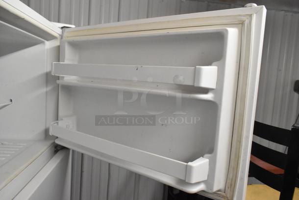 Maytag M1TXEGMYW01 reach-in cooler with freezer, interior shelving visible. Model operates at 115 volts, 1 phase.