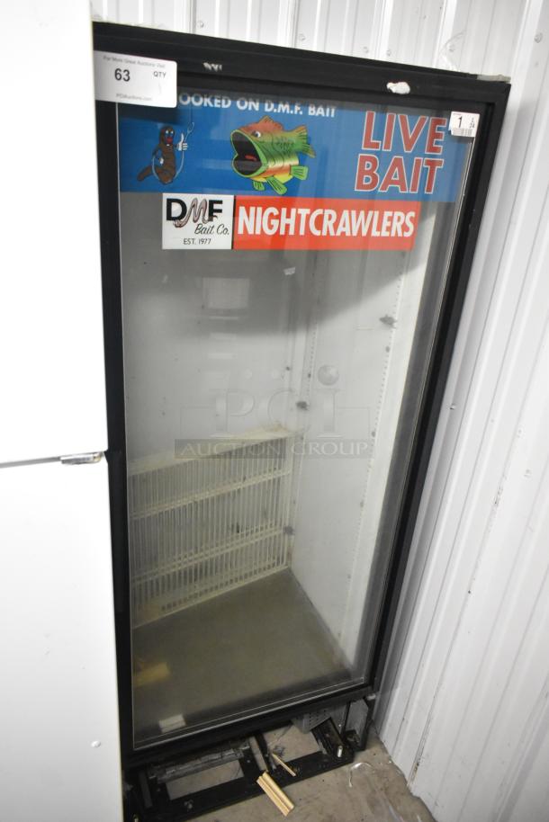 True GDM-12 metal commercial single-door cooler, 115V, 1-phase, with DMF Bait Co. signage, used condition.