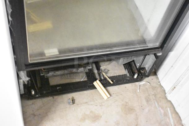 True GDM-12 commercial cooler, metal frame, single glass door, 115V, 1 phase, visible wear, interior view.