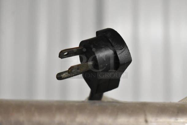 Black electrical plug of Hussmann GSVM-4060 metal commercial merchandiser. 115 volts, 1 phase.