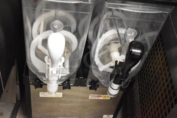 SPM Frosty 2 New stainless steel slushie machine with two hoppers, 115 volts, like new condition with visible pricing tags.