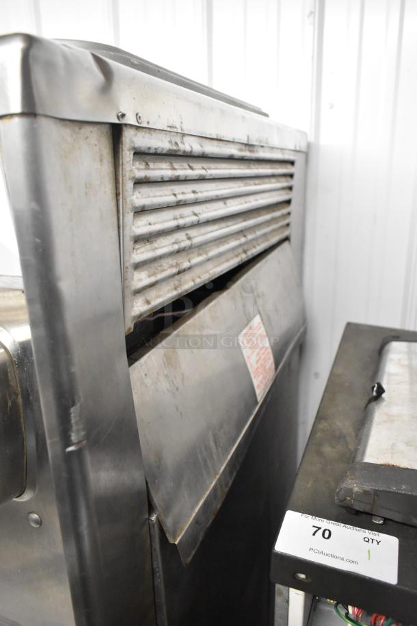Stainless steel 2-flavor soft serve ice cream machine with twist feature, on commercial casters. 208/240V, 3-phase. Visible wear.