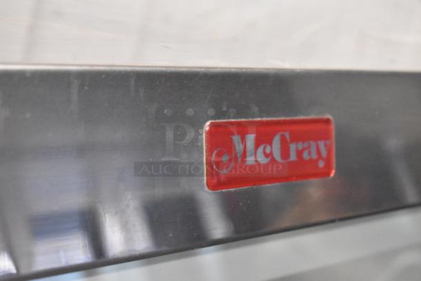 McCray metal commercial floor deli display case with red logo plate. Durable construction. Clean and functional condition.