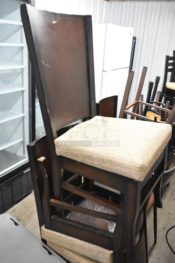 Stack of 19 various chairs, mixed materials, some wear visible. Auction lot: 19 times your bid.