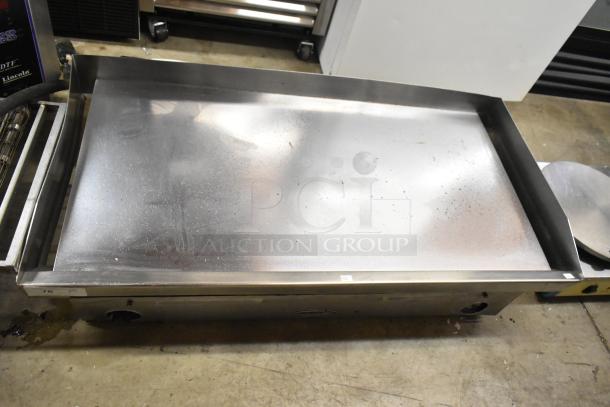 Star stainless steel commercial flat top griddle, used condition, smooth surface, visible controls, countertop model.