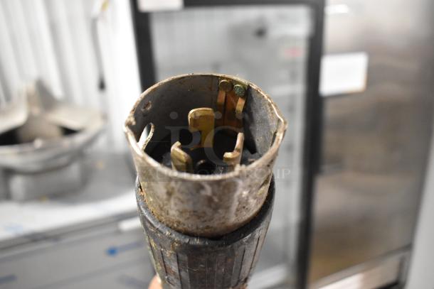 Lincoln Impinger 1961-Q pizza oven connector plug, showing visible wear; part of electric supply setup for commercial use.