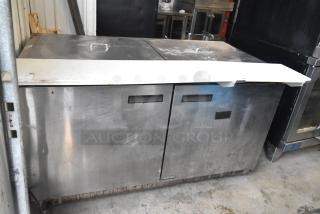 Delfield 4460N-24M-QZN stainless steel commercial prep table with lids, visible wear. 115V, 1 phase.