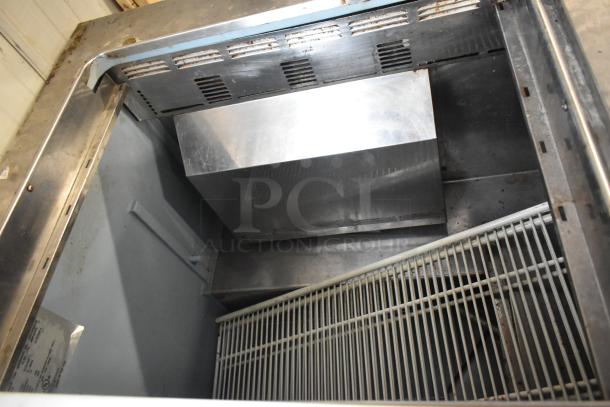 Delfield 4460N-24M-QZN stainless steel commercial prep table, 115V, 1 phase, interior view, showing shelving and ventilation.