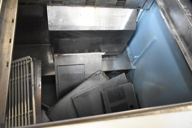 Delfield 4460N-24M-QZN stainless steel commercial prep table interior, showing components, used condition. 115V, 1 Phase.
