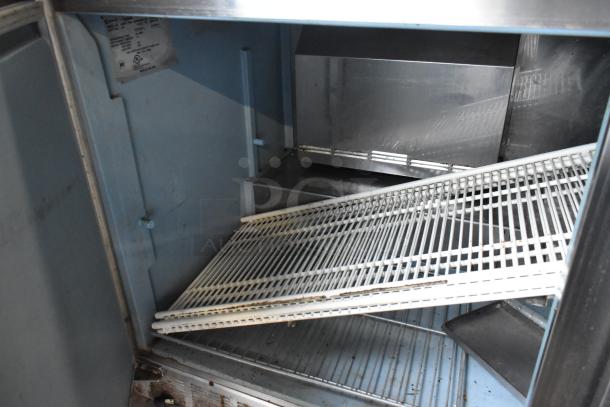 Delfield 4460N-24M-QZN stainless steel commercial prep table, interior view with metal and wire shelving. 115V, 1 phase.