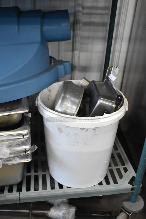 6 brand new scratch and dent stainless steel drop-in bins in a white container, auction lot tag visible.