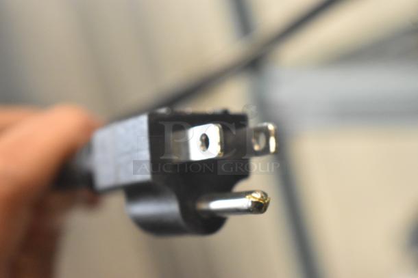 Newco ACE-TS Coffee Machine power plug close-up, showing a standard three-prong connector, slightly scratched.
