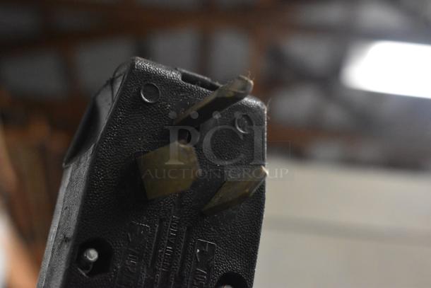 Close-up of a three-prong plug for Moffat commercial kitchen equipment, showing wear and metal prongs.