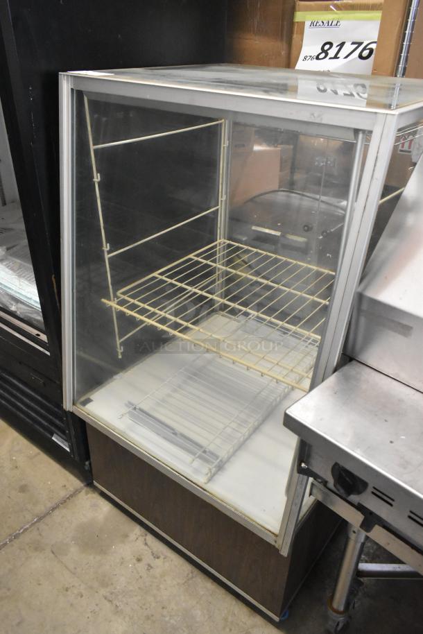 Metal floor style dry display case with glass front, metal shelving, and wood base. Good condition, ideal for store displays.