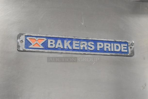 Bakers Pride stainless steel propane gas charbroiler grill, commercial-grade with cover, mounted on casters.