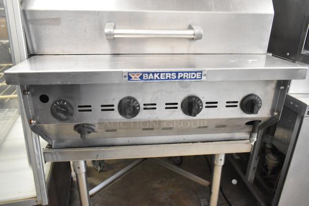 Bakers Pride stainless steel propane charbroiler grill with cover, commercial casters, visible knobs, and brand label.