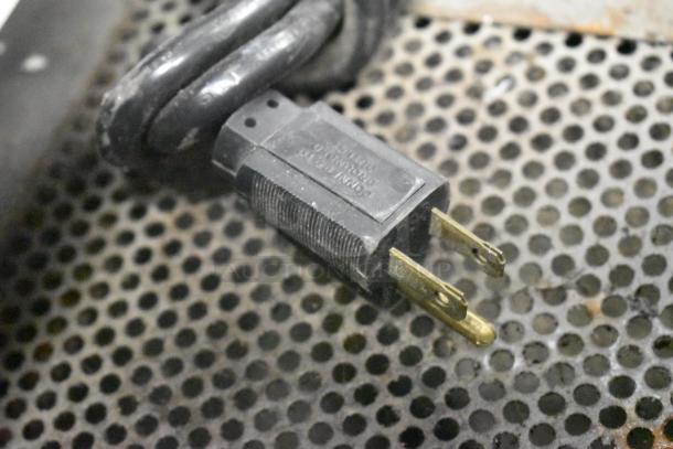 Power plug for Dough Xpress DXE-W Metal Commercial Dough Press, 120 Volts, 1 Phase, on perforated metal surface.