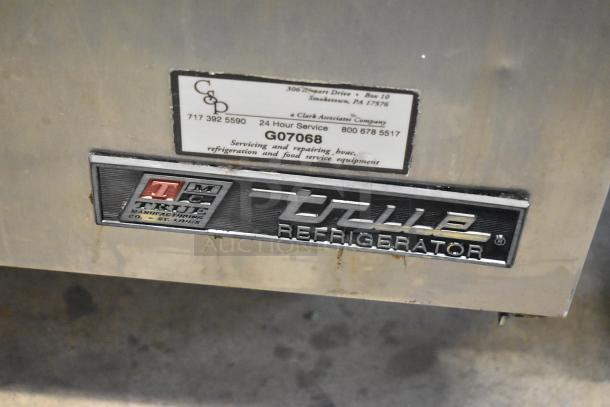 True TSSU-48-12 stainless steel prep table with refrigeration logo and service label. Model details visible.
