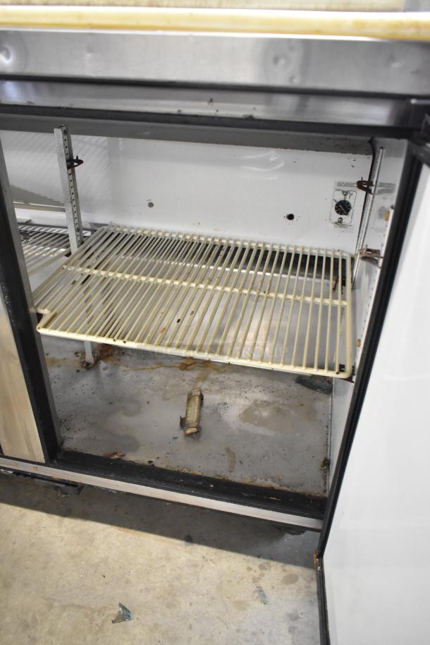 True TSSU-48-12 stainless steel prep table interior; shows shelf and condition. 115 volts, 1 phase.