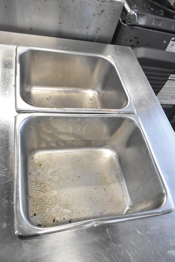 Servolift Eastern 501-2 stainless steel steam table with two compartments, visible wear, on commercial casters.