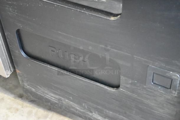 Metal commercial floor-style vending machine with visible "PUSH" marking on a black metal surface.