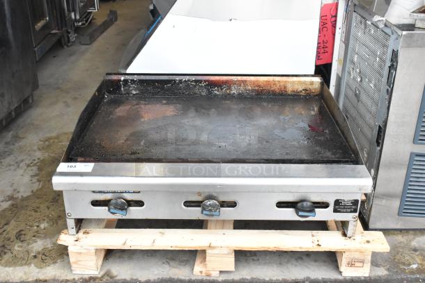 Radiance stainless steel commercial countertop flat top griddle, used condition, with control knobs and a slightly stained surface.