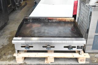 Radiance stainless steel commercial countertop flat top griddle, used condition, with control knobs and a slightly stained surface.