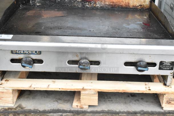 Radiance Stainless Steel Commercial Countertop Flat Top Griddle, shows wear, three control knobs, restaurant equipment label visible.