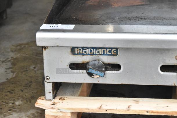 Radiance stainless steel commercial countertop flat top griddle, visible wear, Radiance logo, temperature control knob.