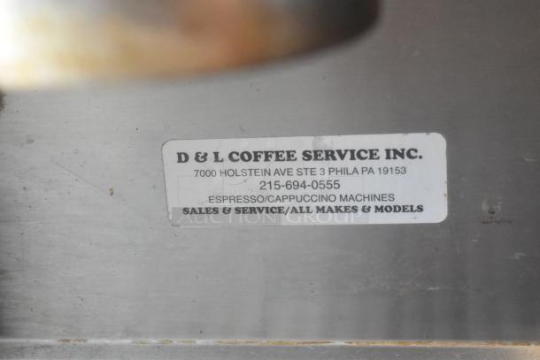Conti Club stainless steel espresso machine with D & L Coffee Service Inc. label indicating sales and service details.