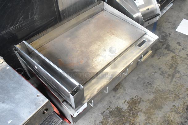 APW Wyott stainless steel commercial countertop flat top griddle, used condition, with visible wear marks.