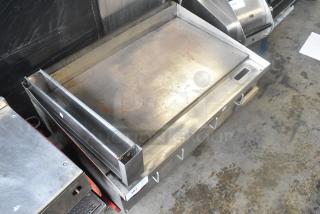 APW Wyott stainless steel commercial countertop flat top griddle, used condition, with visible wear marks.