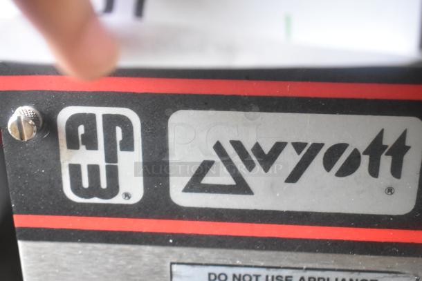 APW Wyott stainless steel commercial countertop flat top griddle label, showcasing brand logo and model information.