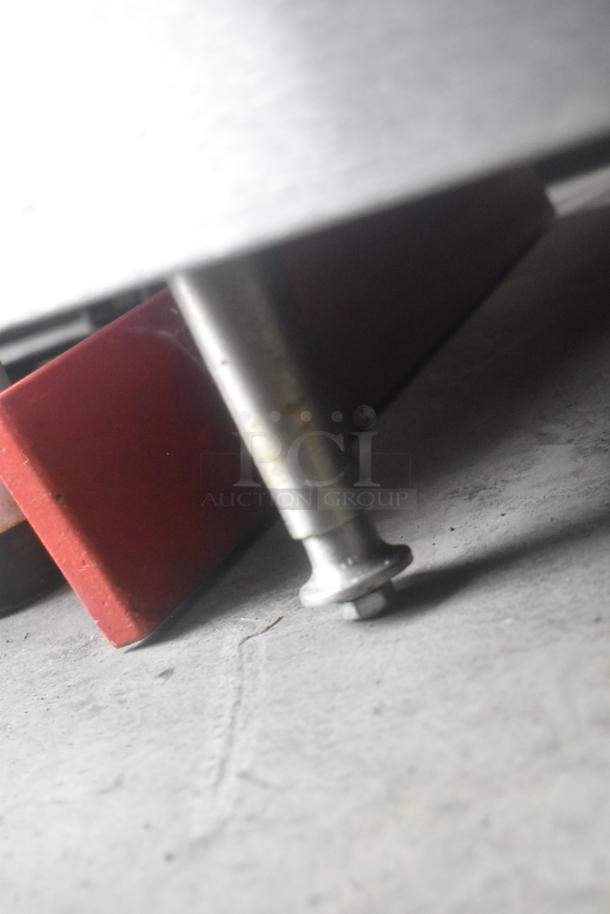 APW Wyott stainless steel countertop flat top griddle leg close-up, showcasing sturdy construction and clean appearance.
