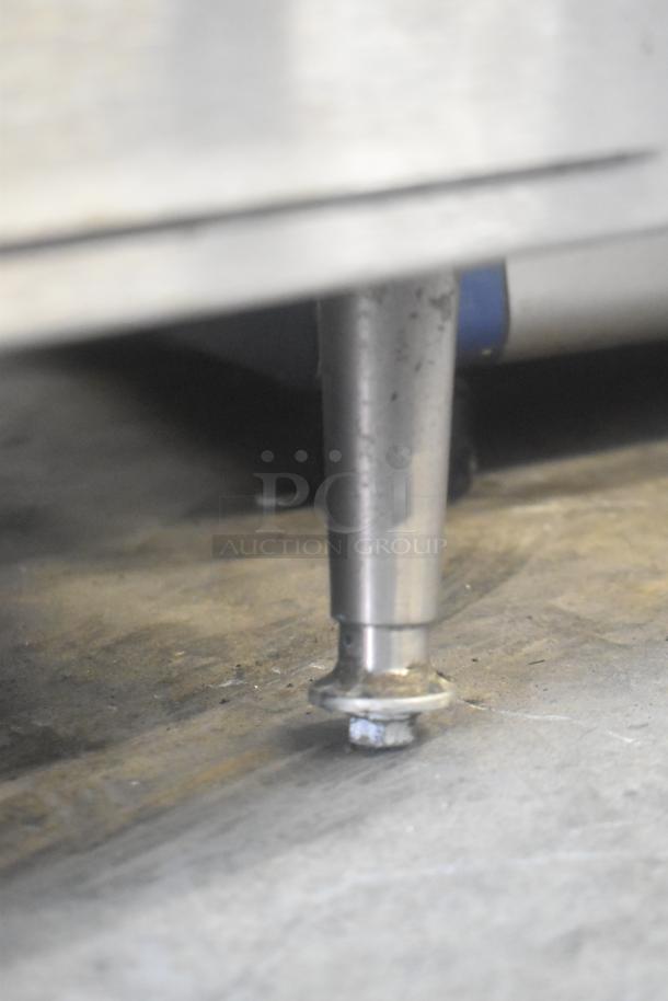 APW Wyott stainless steel leg of commercial countertop flat top griddle, showing sturdy construction and stable base.