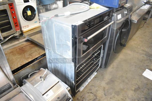 KitchenAid KOCE500EBS11 stainless steel convection wall oven, electric-powered, visible controls, and open oven door.