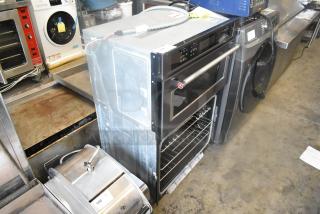 KitchenAid KOCE500EBS11 stainless steel convection wall oven, electric-powered, visible controls, and open oven door.