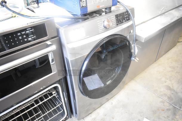 Samsung DVE45B6300P metal front load dryer, 120/240 volts, 1 phase. Silver finish, large capacity, minimal wear visible.
