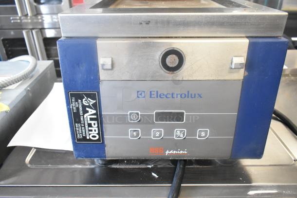 Electrolux HSSPAN stainless steel commercial panini press, 208 volts, 1 phase, with control panel. Slight wear visible.