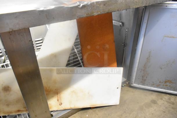 Stainless steel table panels, parts of SLMPREP-2DW Sandwich Prep Table, visible wear, suitable for commercial use.