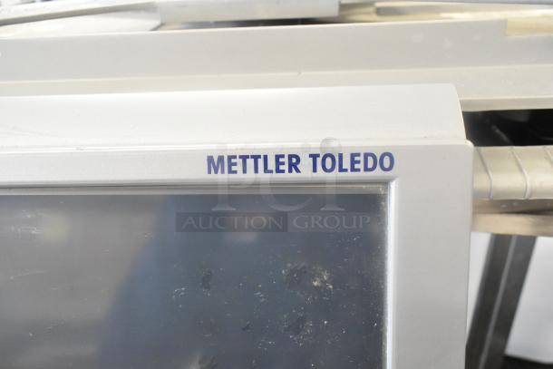 Mettler Toledo 0662 commercial floor wrapping station, metallic finish, brand logo visible, used condition.