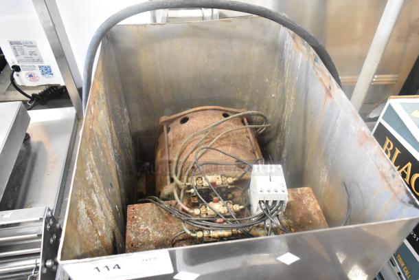 Hobart 4732 metal commercial meat grinder, 208 volts, 1 phase, visible wear and rust, wiring exposed, model label shown.