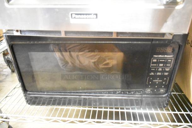 Panasonic NE-1757R commercial microwave and Hamilton Beach microwave, both in used condition, on metal shelving.